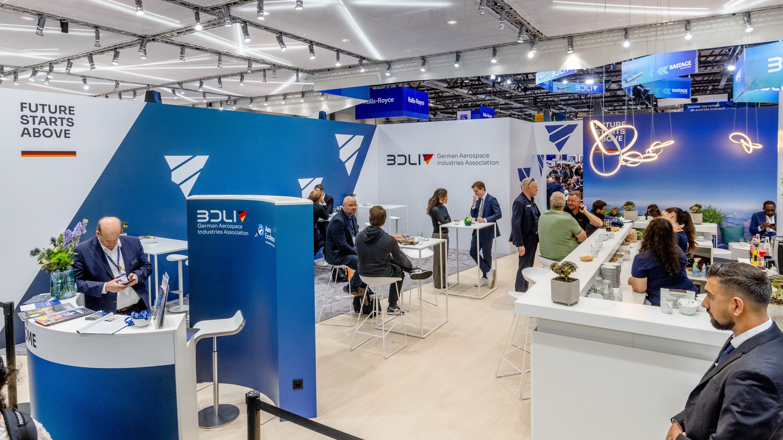 The BDLI stand with reception counter, seating groups and conversations beneath the FUTURE STARTS ABOVE lettering.