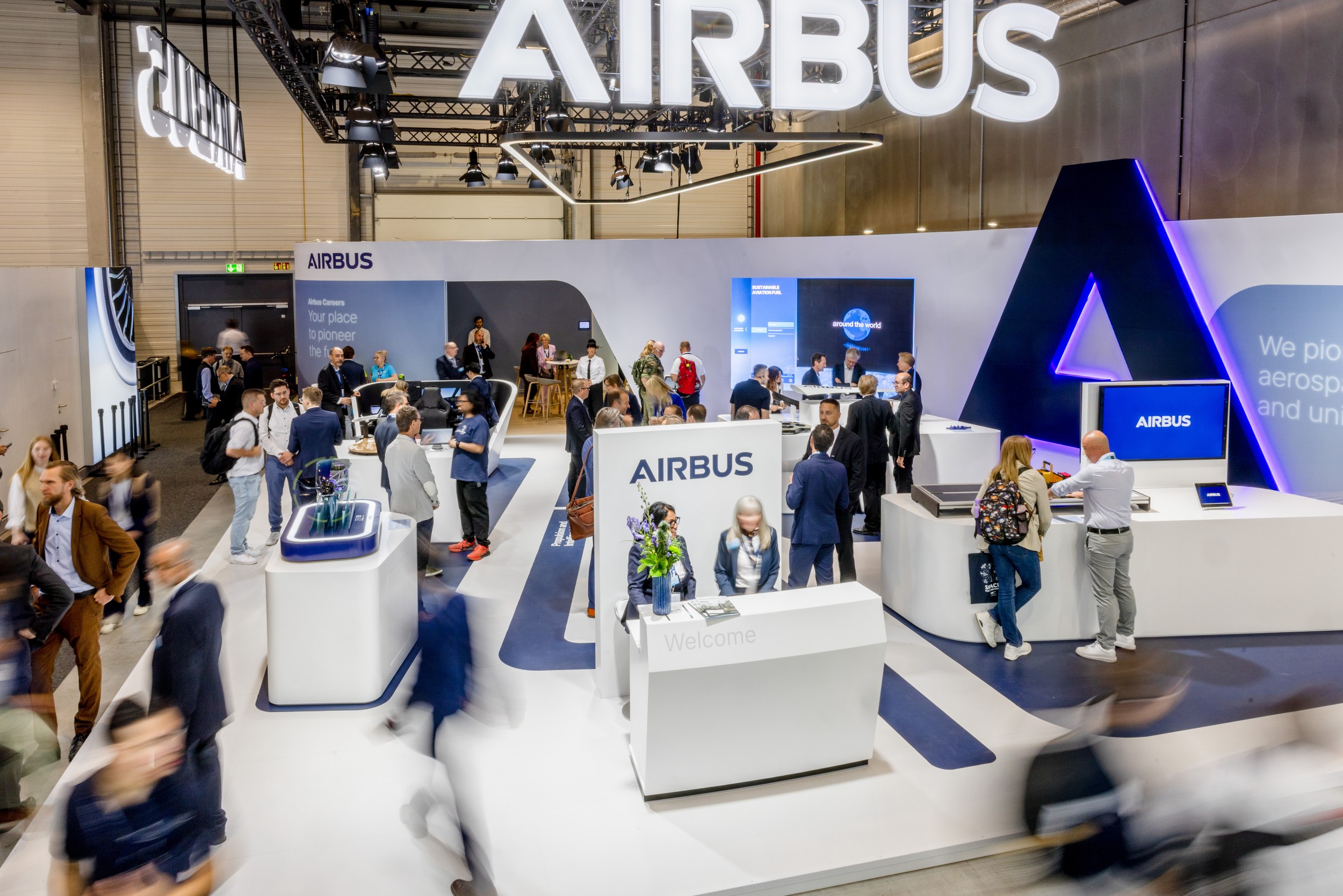 Elevated view of the Airbus stand in Hall C, open on all sides.