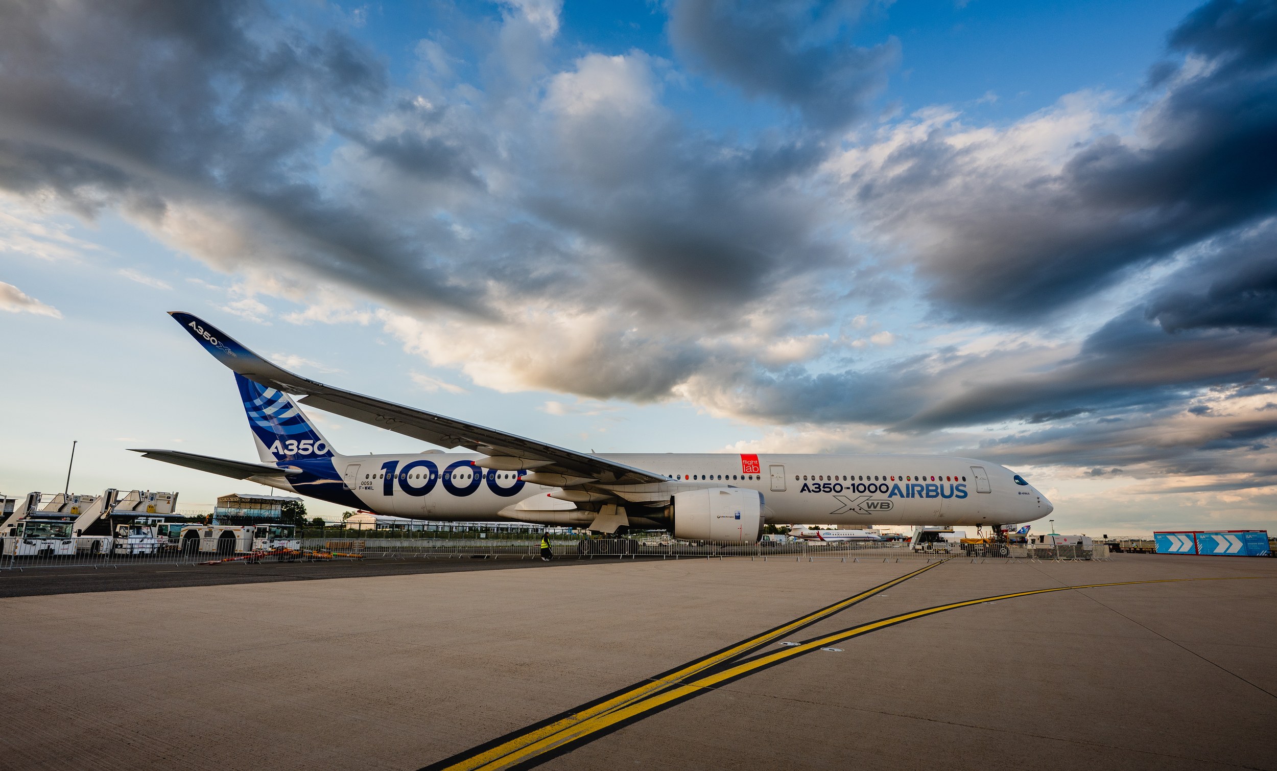 An Airbus A350-1000 stretches across the apron in the static display at ILA Berlin 2026. The wide-angle composition leav
