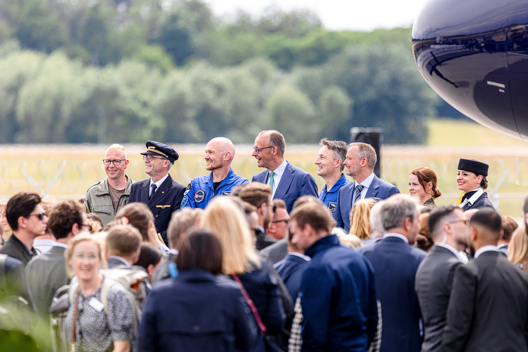 ESA astronauts and Federal Chancellor Friedrich Merz in front of an aircraft nose at ILA 2026